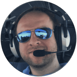 Picture of David with sunglasses and headset in the aircraft